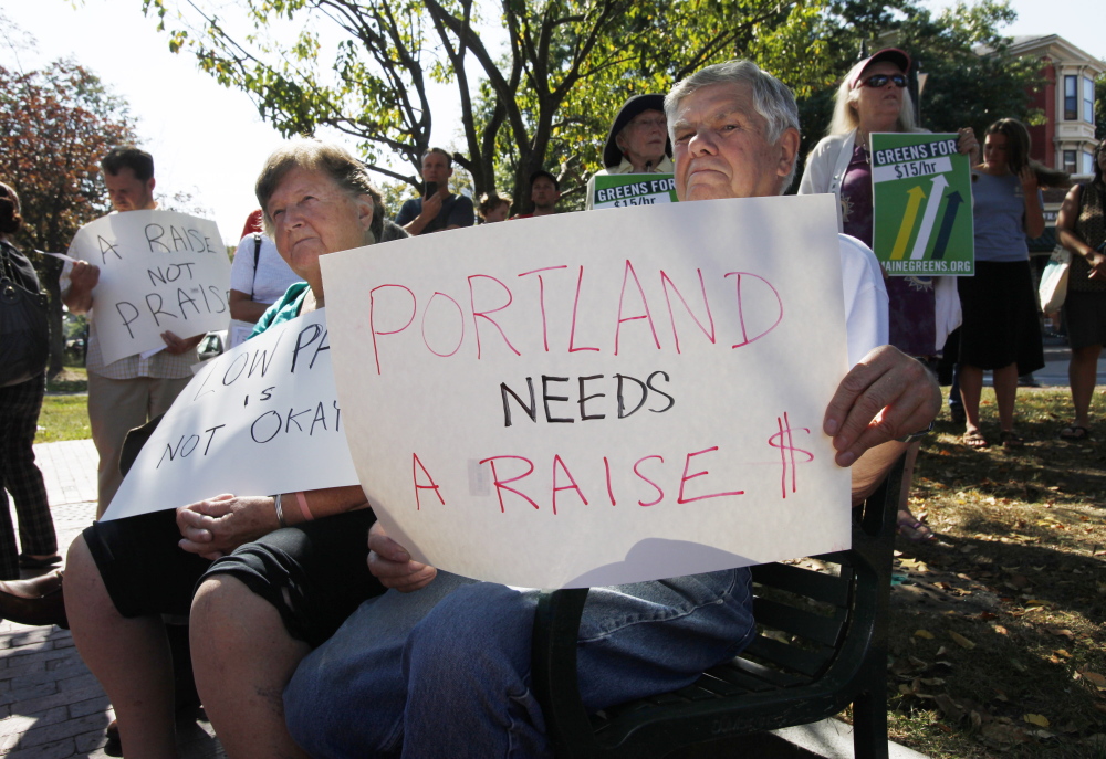 Elden McKeen, right, and his wife, Pat, left, listen to speakers at Monday's Labor Day rally in Portland.