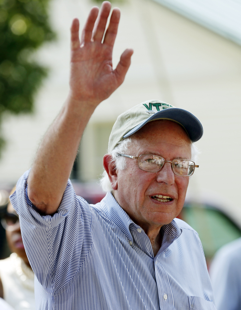 Democratic presidential candidate Sen. Bernie Sanders, I-Vt, waves as he walks in the Labor Day parade Monday, Sept. 7, 2015, in Milford,N.H. (AP Photo/Jim Cole)