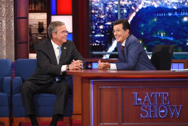 Stephen Colbert talks with Republican presidential candidate Jeb Bush during the premiere episode of “The Late Show” on Tuesday in New York. Bush and actor George Clooney were the guests for Colbert’s debut.