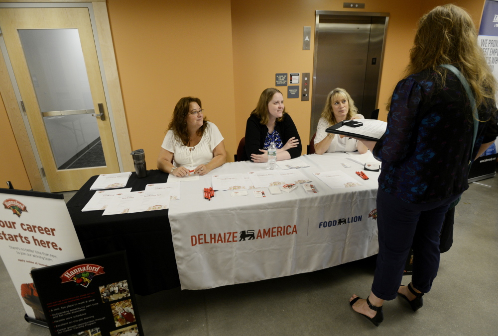 Holly Norburg of Old Orchard Beach, standing, meets with Hannaford associate relations managers, from left, Karen Badger, Lisa Lombard and Melissa Cyr during a job fair Wednesday at the Greater Portland CareerCenter.