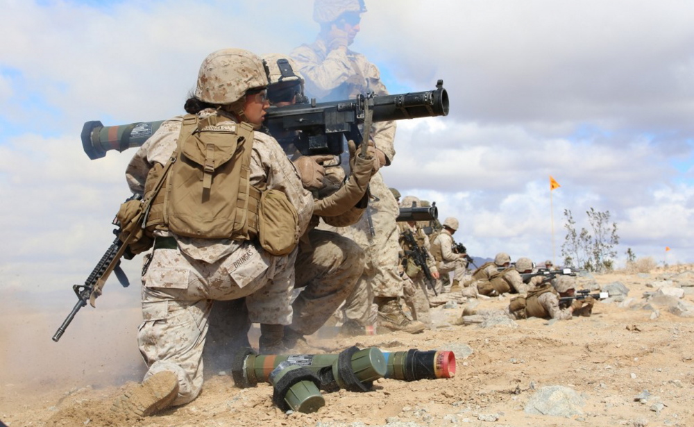 Marine Sgt. Emma A. Bringas and Lance Cpl. Terrence A. Lay fire an assault weapon during a pilot test of the Ground Combat Element Integrated Task Force, a unit created by the Marine Corps to see how women could better be included in combat units.