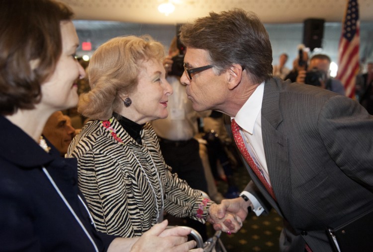Republican presidential candidate and former Texas Gov. Rick Perry is greeted by audience members after speaking at an event sponsored by the Eagle Forum in St. Louis on Friday. During the speech Perry said he is ending his second bid for the Republican presidential nomination.