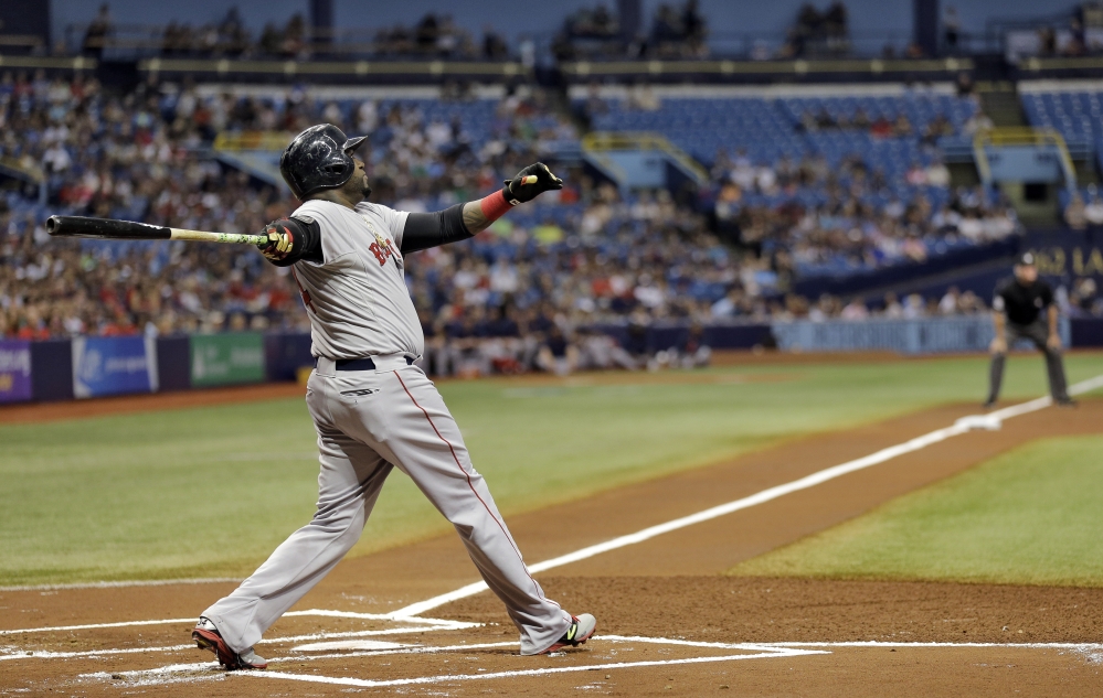 Boston Red Sox’s David Ortiz follows the flight of his three-run home run off Tampa Bay Rays starting pitcher Matt Moore in the first inning Saturday in St. Petersburg, Fla.  Boston’s Mookie Betts and Xander Bogaerts also scored. 