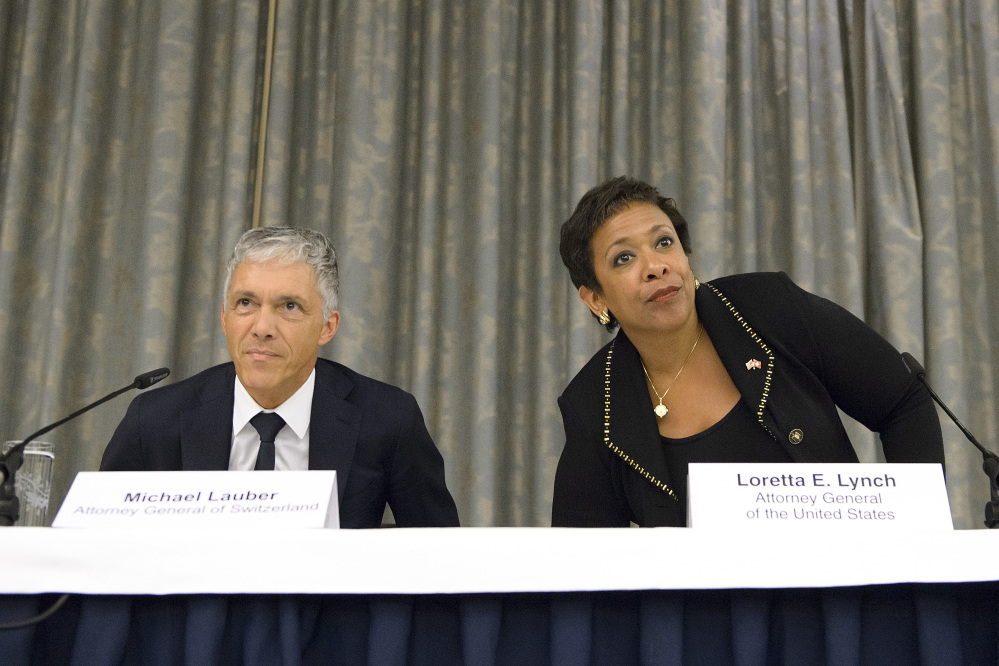 Michael Lauber, attorney general of Switzerland, left, and Loretta Lynch, attorney general of the US, right, arrive for the a news conference on soccer related criminal proceedings, in Zuerich, Switzerland, Monday, Sept. 14, 2015. Lynch expects more indictments in FIFA corruption investigation.