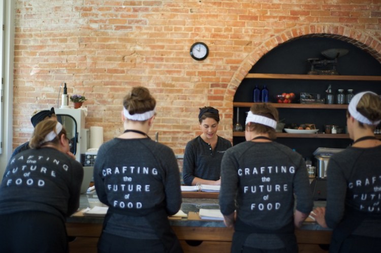 Students work in the kitchen of Matthew Kenney’s culinary academy in Belfast.