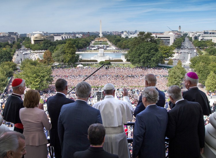 Pope Francis waves to the assembled crowd from the Speakers Balcony at the U.S. Capitol with members of Congress on Thursday.
Doug Mills/The New York Times via AP
