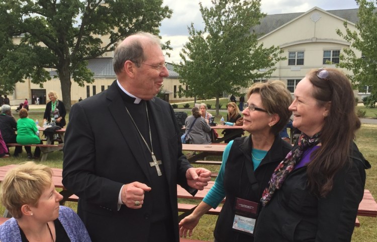 Bishop Robert Deeley, head of the Roman Catholic Diocese of Portland, chats with pilgrims Vanessa Madore, left, Monica Cote and Nancy Grover, all of Saint Paul the Apostle Parish in Bangor, at the National Shrine of Our Lady of Czestochowa in Doylestown, Pa.