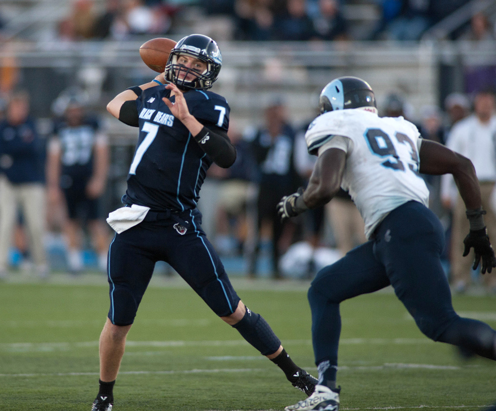 Maine quarterback Dan Collins gets pressure from Rhode Island defender Jose Duncan. Collins completed 14 of 25 passes for 211 yards, with no touchdowns or interceptions.