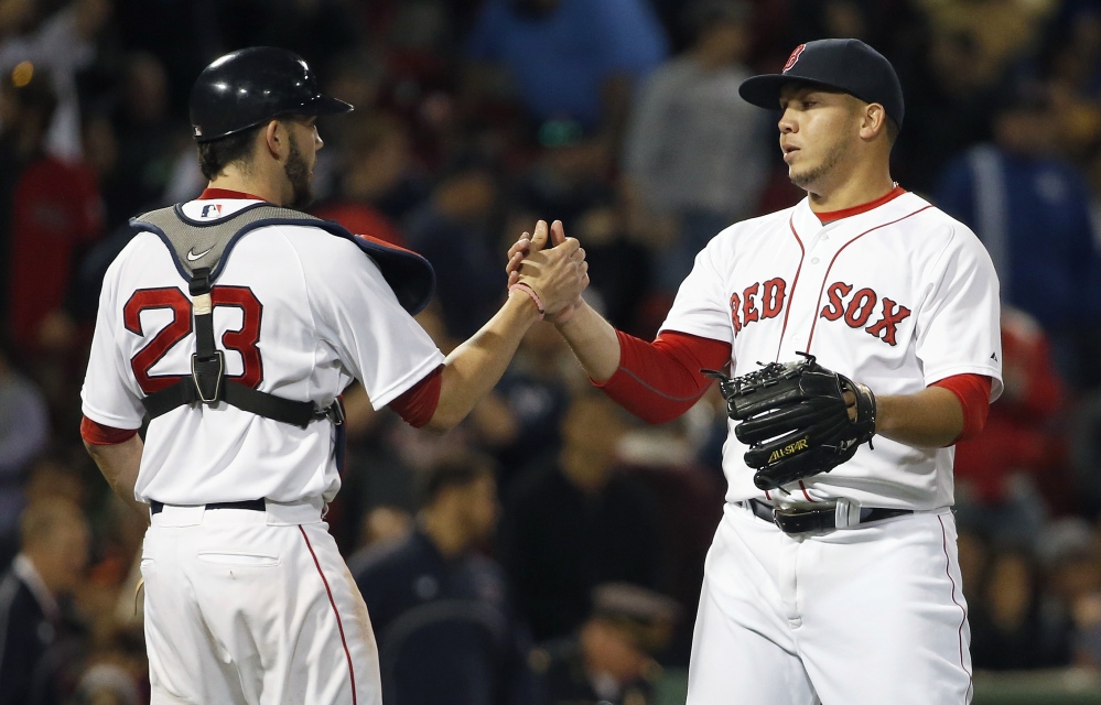 Red Sox’s Jonathan Aro, right, and Blake Swihart celebrate after defeating the Baltimore Orioles 8-0 in Boston on Saturday.