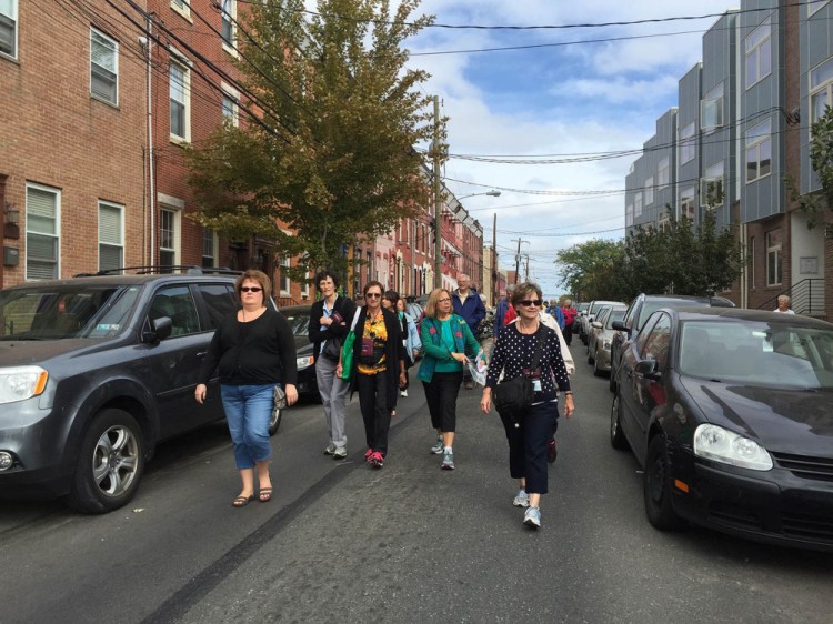 Mainers on a pilgrimage organized by the Roman Catholic Diocese of Portland make their way down 19th Street in Philadelphia on Sunday toward security screenings before attending the Mass celebrated by Pope Francis. Kelley Bouchard/Staff Writer