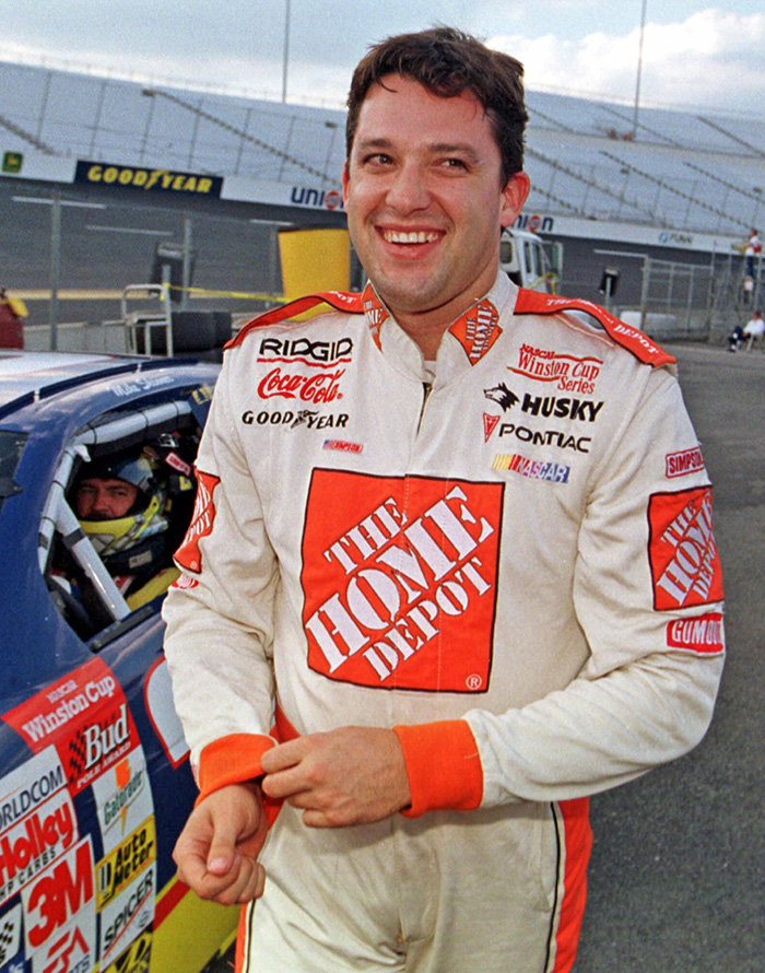 In this Sept. 10, 1999, photo, Tony Stewart smiles after congratulating Mike Skinner after Skinner bumped Stewart off the pole during qualifying for the Exide 400 at Richmond International Raceway. Stewart won the race for his first NASCAR Winston Cup win. The Associated Press