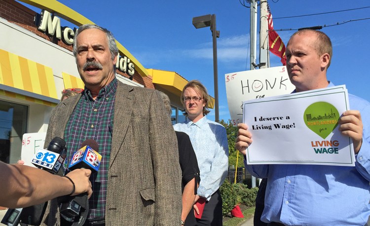 Harlan Baker of the Southern Maine Labor Council, left, speaks at a news conference outside McDonald's restaurant in Portland on Monday to promote a proposed $15-per-hour citywide minimum wage that goes to city voters Nov. 3. At right is Tom MacMillan, chairman of the Portland Green Independent Committee and candidate for mayor.