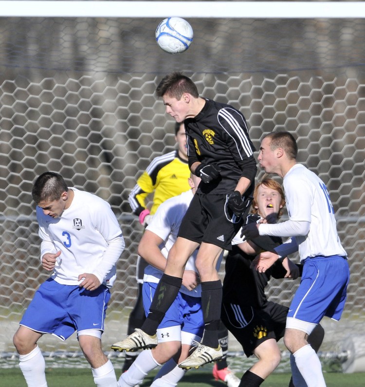 Maranacook’s Kent Mohlar (13) elevates to head the ball off a corner kick in front of the Madawaska goal in the Class C state championship game last season at Hampden Academy.