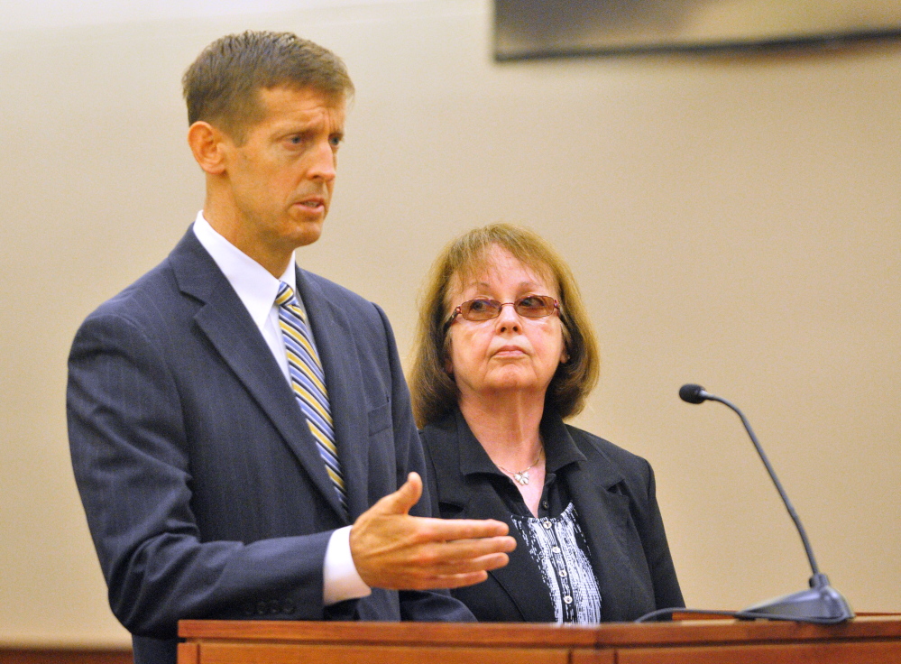 Attorney Walt McKee stands with Claudia Viles as she pleads not guilty Sept. 17 during an initial appearance in Kennebec County criminal court in Augusta. She is charged with 13 counts related to tax fraud at the Anson Town Office.