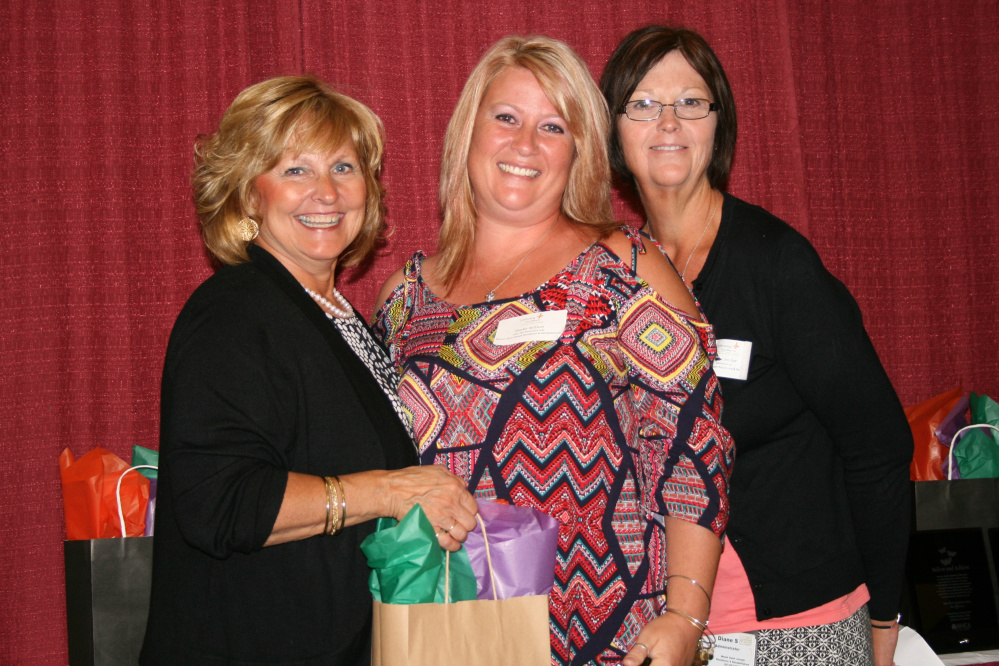 Maine first lady Ann LePage, left, presents Heather McEwen, middle, with the MHCA 2015 Caregiver Excellence Award. Joining McEwen and LePage is Mount St. Joseph Administrator Diane Sinclair.