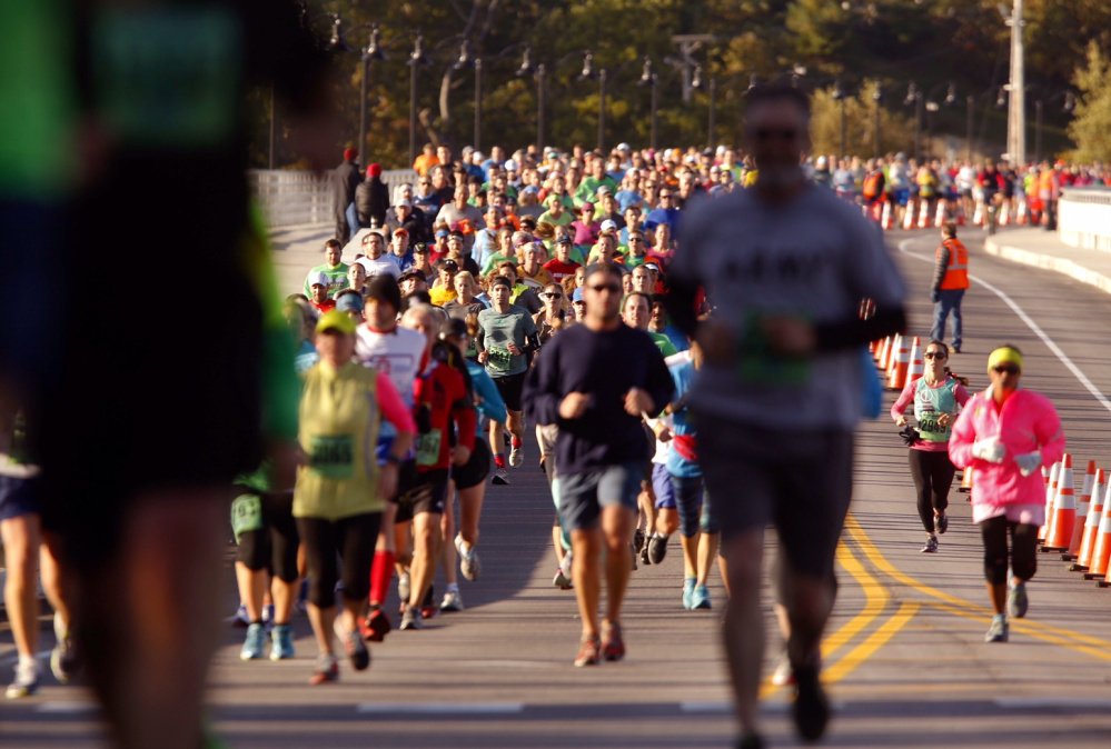 Maine Marathon runners cross the Route 1 bridge into Falmouth during Sunday’s race.