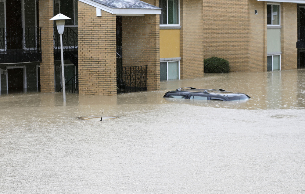 Flood waters engulf cars at an apartment complex in Columbia, S.C., Sunday, Oct. 4, 2015. The rainstorm drenching the U.S. East Coast brought more misery Sunday to South Carolina, cutting power to thousands, forcing hundreds of water rescues and closing many roads because of floodwaters. (AP Photo/Chuck Burton)