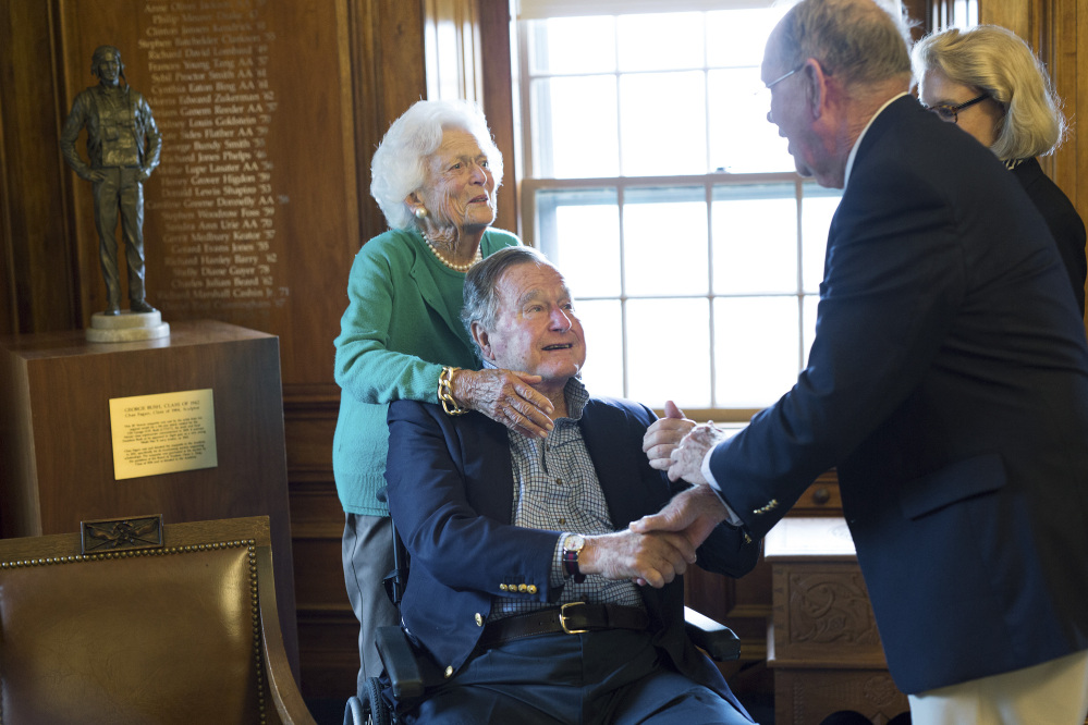 Former President George H.W. Bush, with his wife Barbara, speaks with former baseball teammate Richard Phelps, during a visit to Phillips Academy in Andover, Massachusetts. Bush is healing well after taking a fall this summer.
