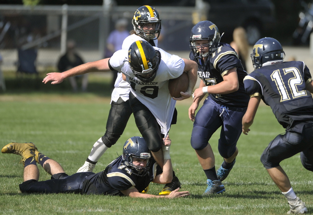 Portand Press Herald photo by John Ewing 
 Maranacook quarterback Kyle Morand tries to break free from a host of Traip defenders, inlcuding Justin Barnaby (74), Shelton Thomas (57) during a game last month in Kittery.