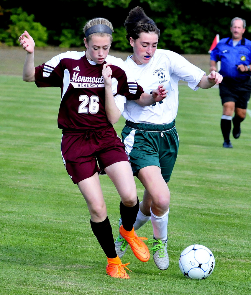 Staff photo by David Leaming 
 Monmouth's Emily Grandahl, left, and Carrabec's Katrina Mason compete for possession during a Mountain Valley Conference game Monday afternoon.