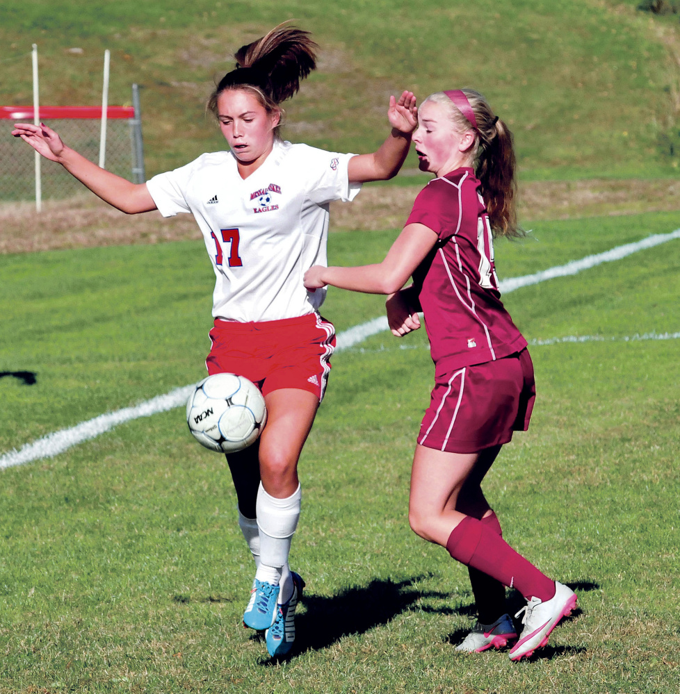 Staff photo by David Leaming 
 Messalonskee's Edin Sisson, left, tries to maintain possession of the ball as Bangor's Maddi Cormier defends during a Kennebec Valley Athletic Conference Class A game Tuesday in Oakland.