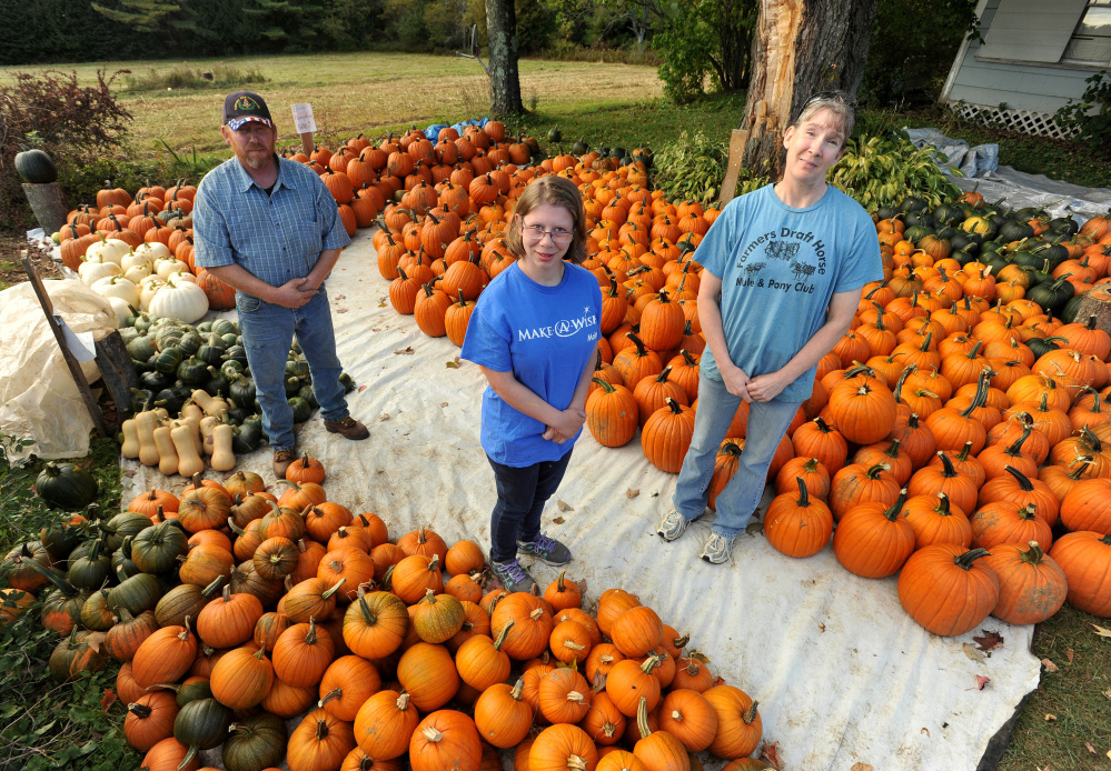 Abbie Clark, center, recipient of the Make-A-Wish Foundation, stands for photo with Dan Ring, left, and wife Allison Ring, right, at Ring Family Farm in Canaan on Tuesday. Ring Family Farm will host its 6th annual fall event to raise money for the Make-A-Wish Foundation on Saturday.