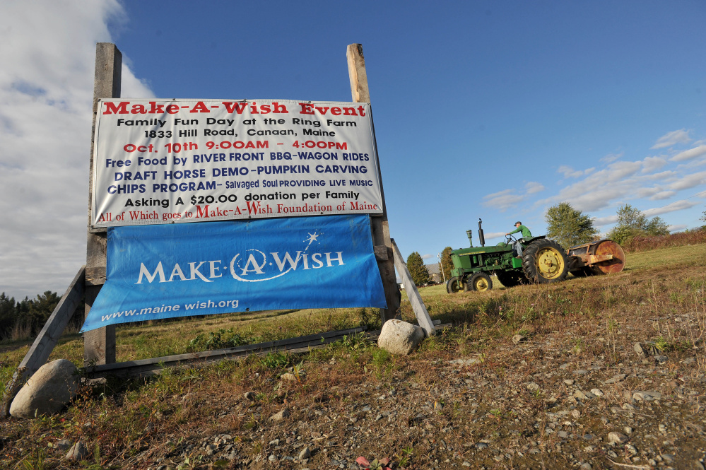 Will Ring compacts the grass for parking at the Ring Family Farm in anticipation of Saturday’s 6th annual Make-A-Wish Foundation fundraiser in Canaan on Tuesday.