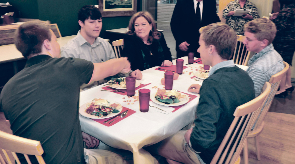 Chief Justice Leigh Saufley of the Maine Supreme Judicial Court shakes hands with Mt. Blue High School student Miles Pelletier and other students during lunch following the court hearing arguments for appeals on Wednesday.