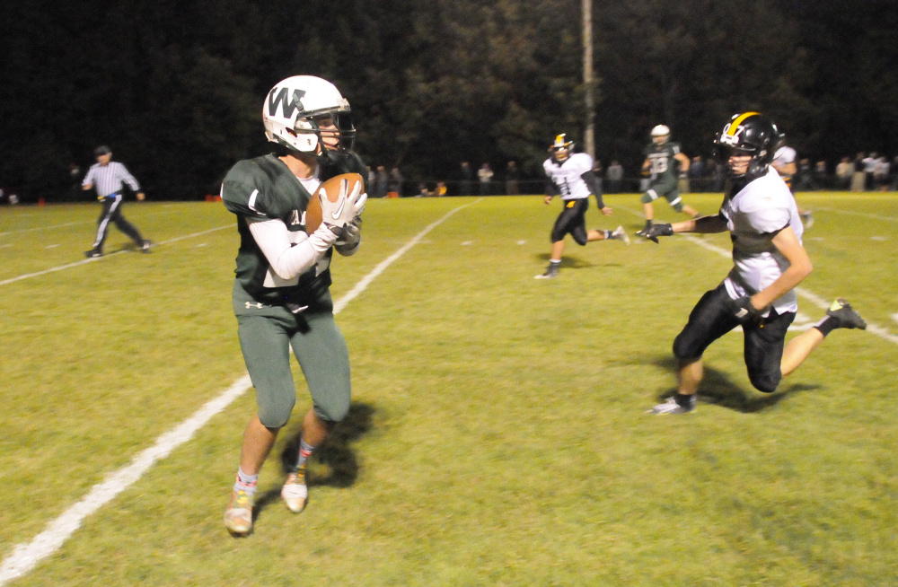 Winthrop/Monmouth’s Bennett Brooks, left, catches a pass in front of Maranacook’s Levi Emery during a game this season.