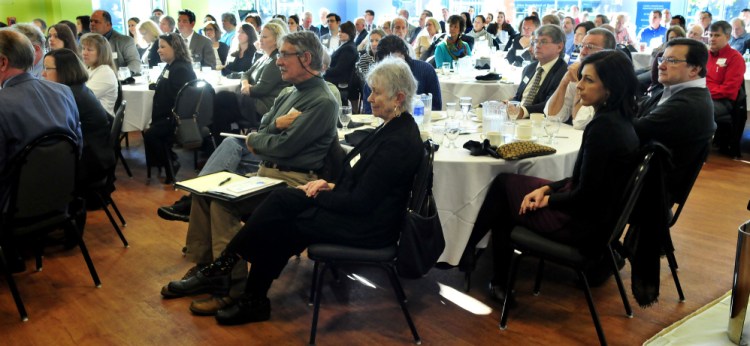 People with area businesses and organizations listen to speakers during a Business Breakfast series on development at Thomas College in Waterville on Thursday.