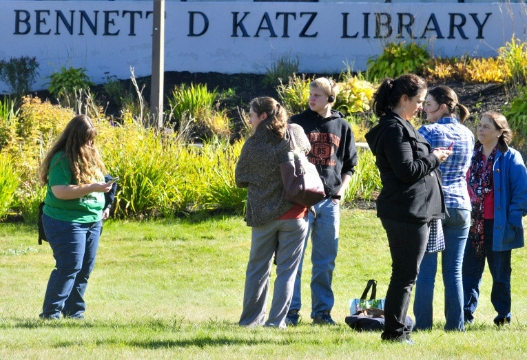 People wait outside the Katz Library at the University of Maine at Augusta Thursday afternoon.