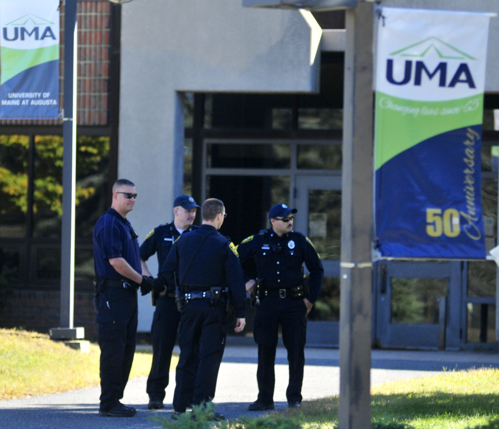 Police walk outside the Katz Library at the University of Maine at Augusta Thursday afternoon.