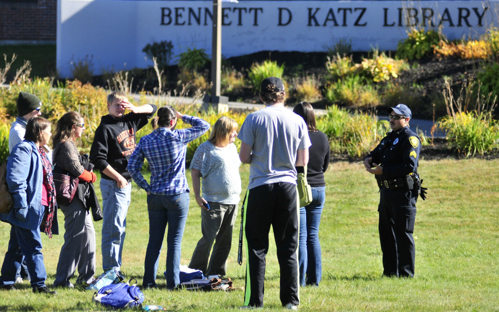 People wait outside the Katz Library at the University of Maine at Augusta Thursday afternoon.