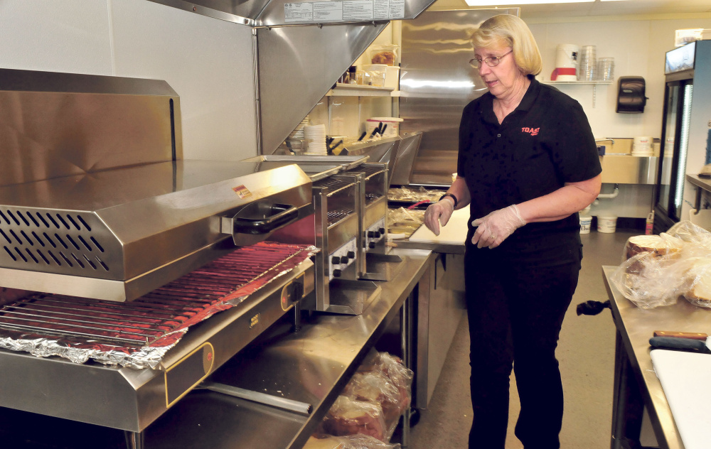 Toast XPress owner Cindy Scott prepares to make breakfast at the new diner in Waterville in October 2015.