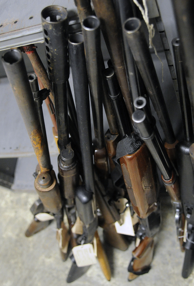 Rifles and shotguns are seen in storage Wednesday at Augusta police headquarters.