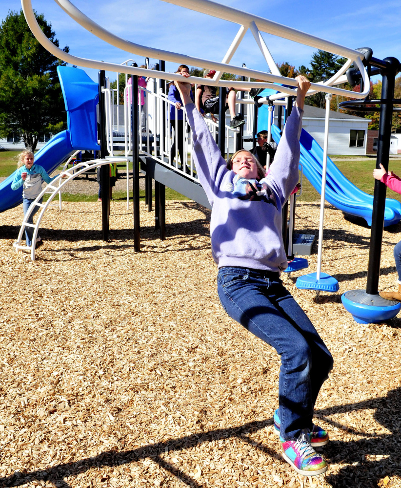 Makayla Wallingford plays on new equipment at Canaan Elementary School on Thursday. Two years in the making, the playground is also open to the community at large.