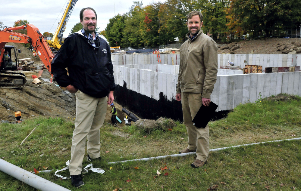 Jeff McKay, left, director of facilities management at the University of Maine at Farmington, and Luke Kellett outside the biomass central heating plant site near the campus in Farmington.