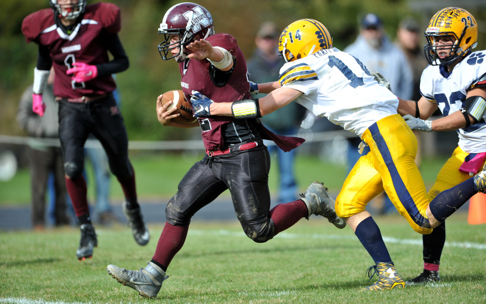 Nokomis High School’s Brock Graves (12) scores a touchdown as Mt. Blue High School’s Nate Pratt-Holt (14) tries to make the tackle on Saturday in Newport.