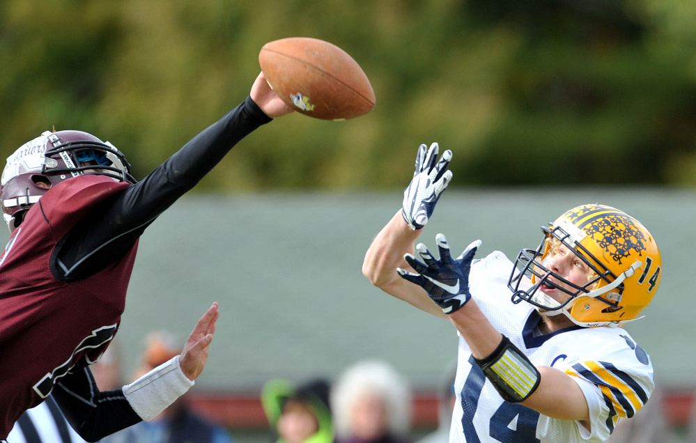 Nokomis High School’s Isaac Thibodeau (14) breaks up a pass intended for Mt. Blue High School’s Nate Pratt-Holt (14) on Saturday in Newport.