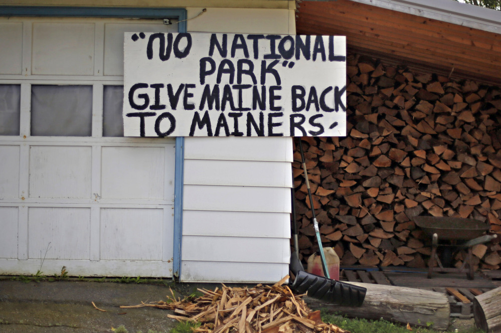 A sign in opposition to a proposed national park is seen on a home in Millinocket.