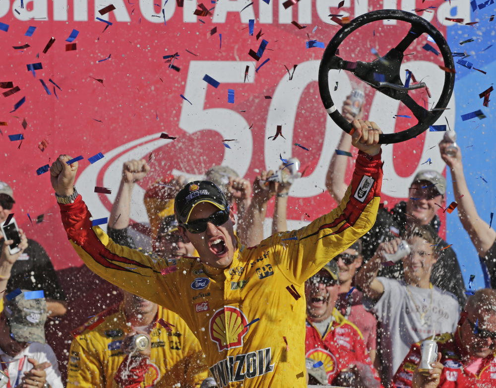 Joey Logano celebrates in Victory Lane after winning the Bank of America 500 at Charlotte Motor Speedway on Sunday in Concord, N.C.
