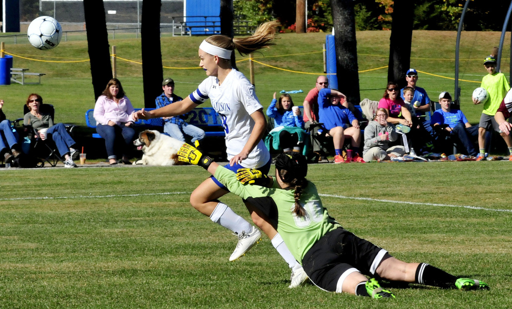 Madison’s Kayla Bess goes after the ball as Monmouth keeper Mikayla Cameron defends Monday in Madison.
