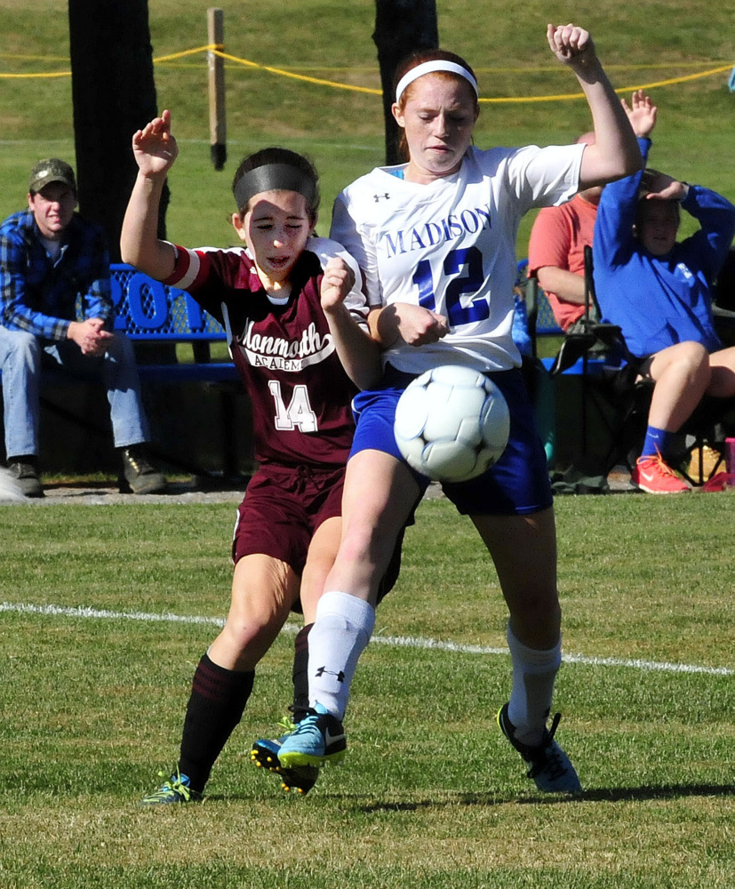 Monmouth’s Taylor Spadafora and Madison’s Ashley Emery collide while going for the ballMonday in Madison.