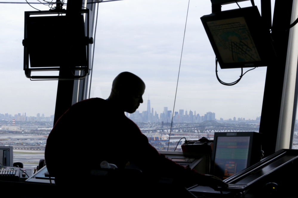 In this May 21, 2015 file photo, an air traffic controller works in the tower at Newark Liberty International Airport in Newark, N.J.