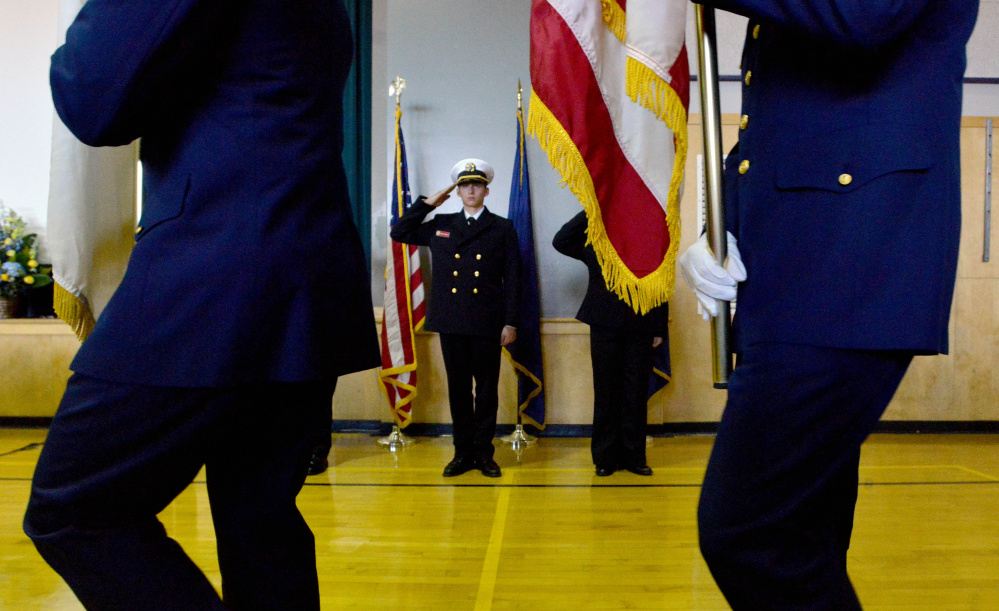 Members of the U.S. Coast Guard color guard march into the Jay Community Building with the American flag during a celebration of Michael Holland’s life on Wednesday.