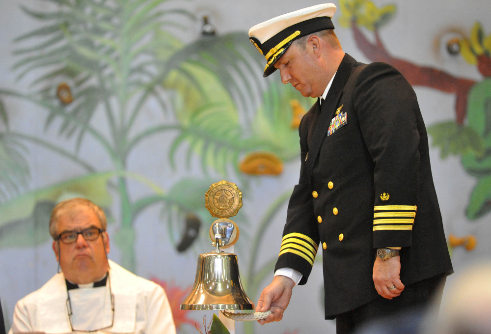 Chaplain Commander Clifford Stuart rings the bell for each life lost on the EL Faro crew during a celebration of crew member Michael Holland’s life at the Jay Community Building on Wednesday.