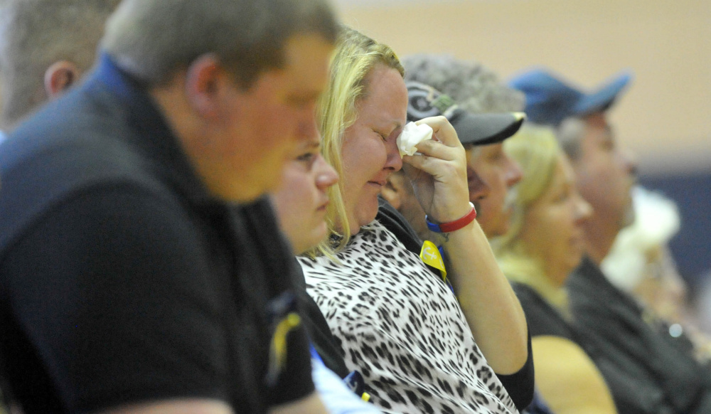 Friends and family of Michael Holland become emotional during a celebration of Holland’s life at the Jay Community Building on Wednesday.