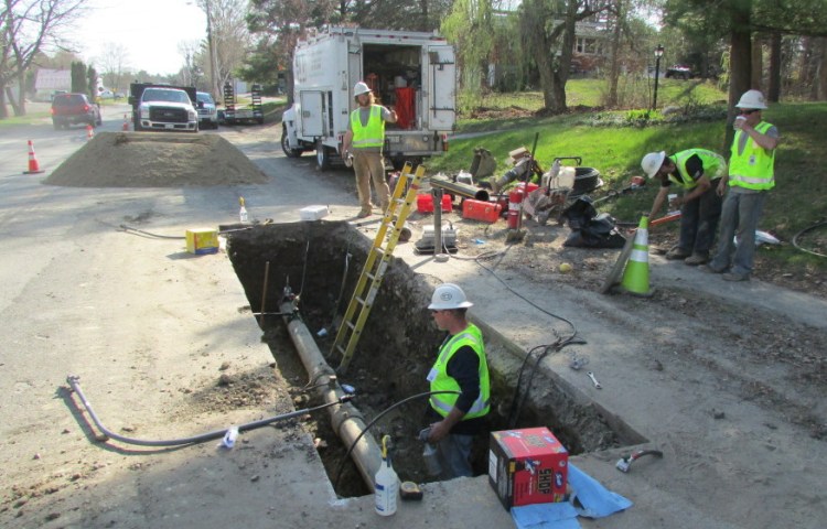 Employees from ETTI, a utilities construction company from Lisbon Falls, replace an electrofusion tee on a Summit Natural Gas line in April on Cool Street in Waterville. Summit has been ordered by state regulators to inspect hundreds additional pipeline connections that may be faulty.