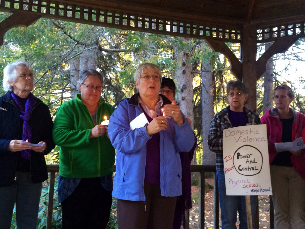 Nan Bell, a community educator at the Family Violence Project, speaks to attendees at a domestic violence awareness vigil Wednesday at Coburn Park in Skowhegan. The vigil included a moment of silence in which the names and stories of victims of domestic violence homicides this year were read aloud.
