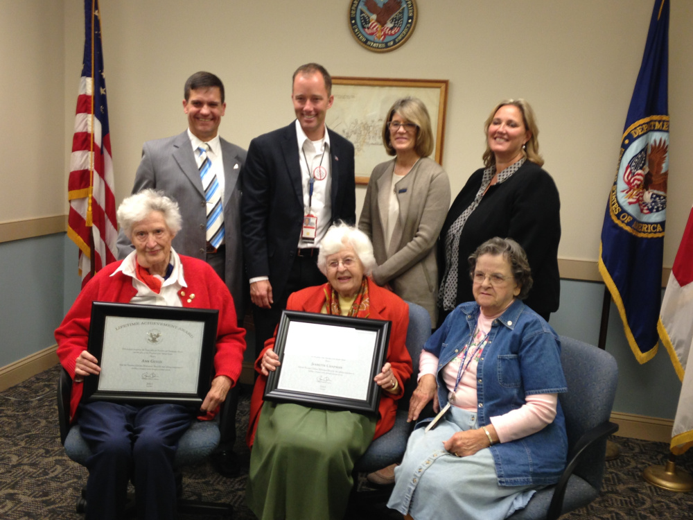 Ann Guild, front left, and Jeannette Chapman display the President’s Lifetime Achievement Award recognizing them for 95 years of combined volunteer service to the American Red Cross at Maine VA Medical Center. The Red Cross honored the women Thursday during a ceremony at the medical center that included, back row, left to right, retired U.S. Air Force Col. Eric Gates, manager of Services to the Armed Forces for the Red Cross; Ryan Lilly, director of the Maine VA Healthcare System; Patricia Murtagh, CEO of the American Red Cross in Maine; April Caron, executive director of the American Red Cross of Central and Mid Coast Maine; and Ellie Mills, front right, who has volunteered for the Red Cross at the medical center for the past four years.